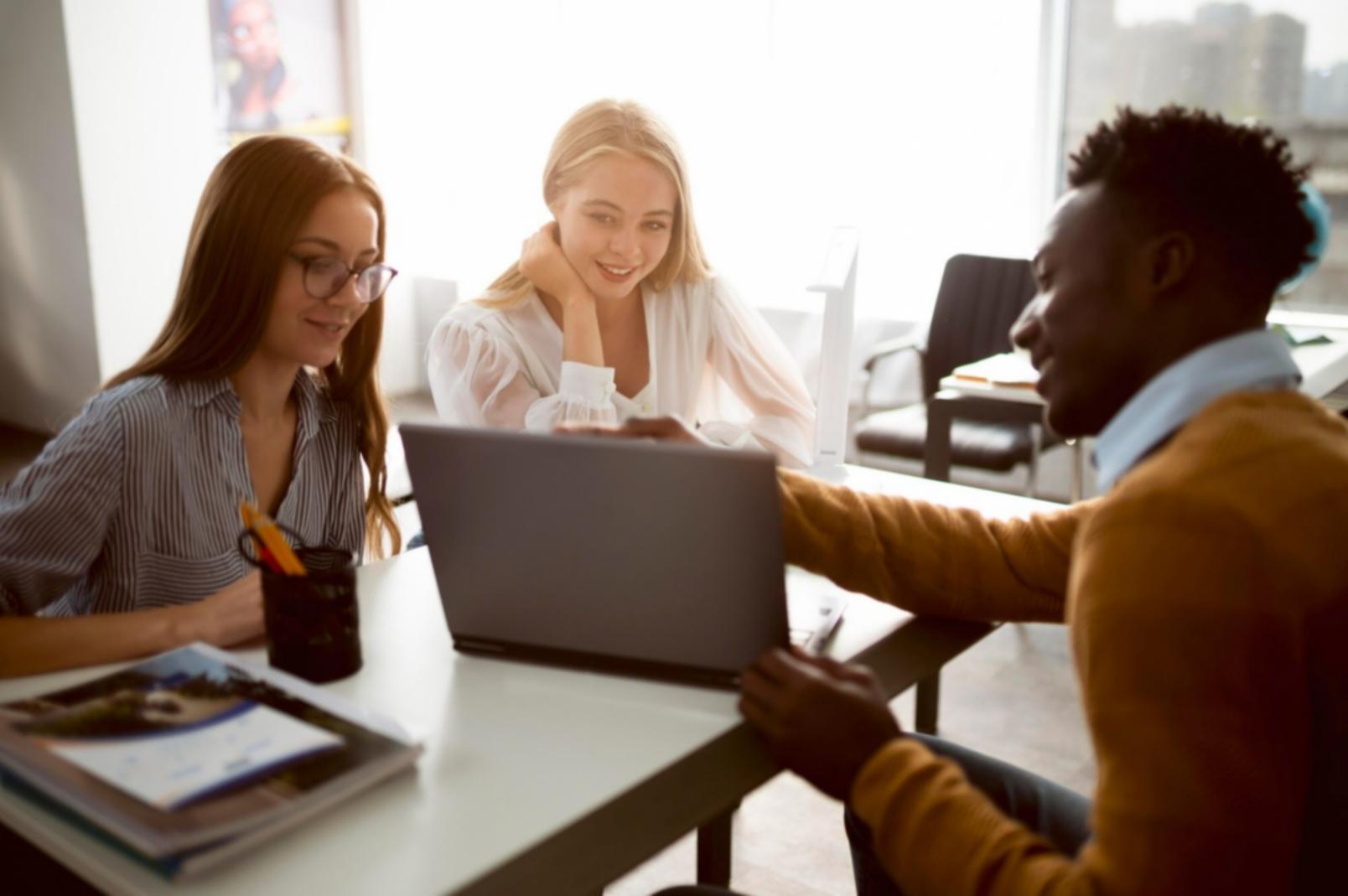 Collaborative workspace with business professionals analyzing financial data together